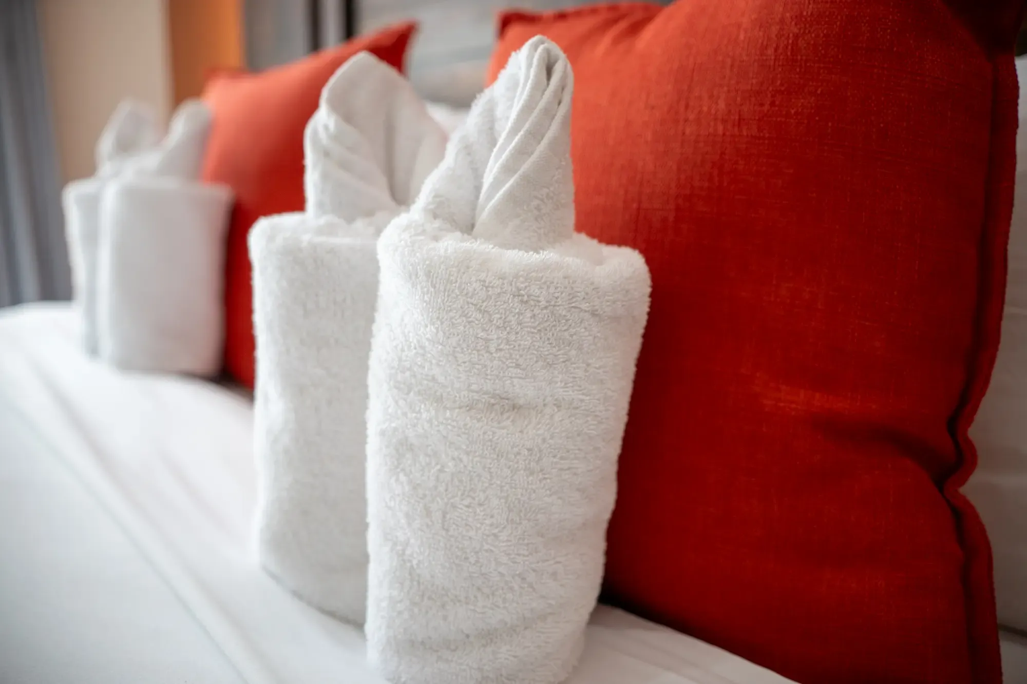 Folded fresh towels on the bed